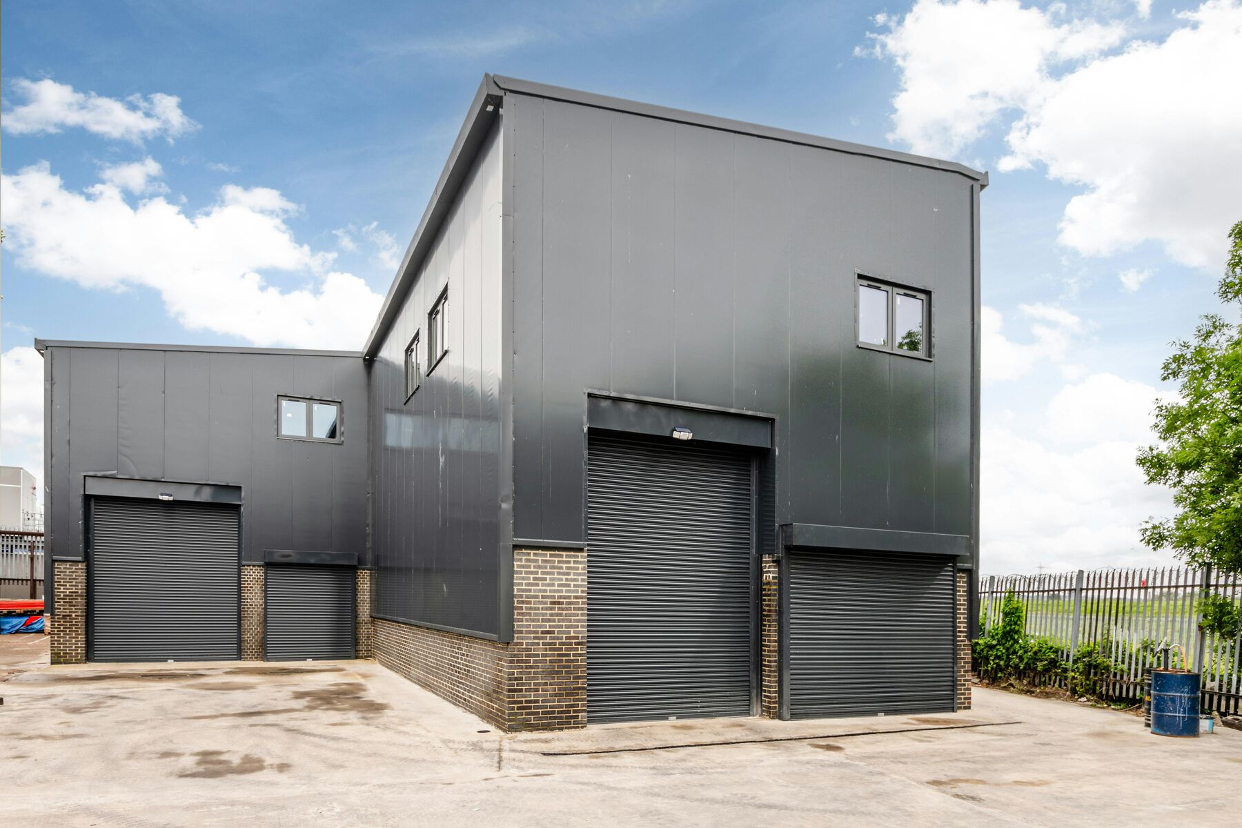 Terrace of new industrial units with brickwork bases and profiled cladding