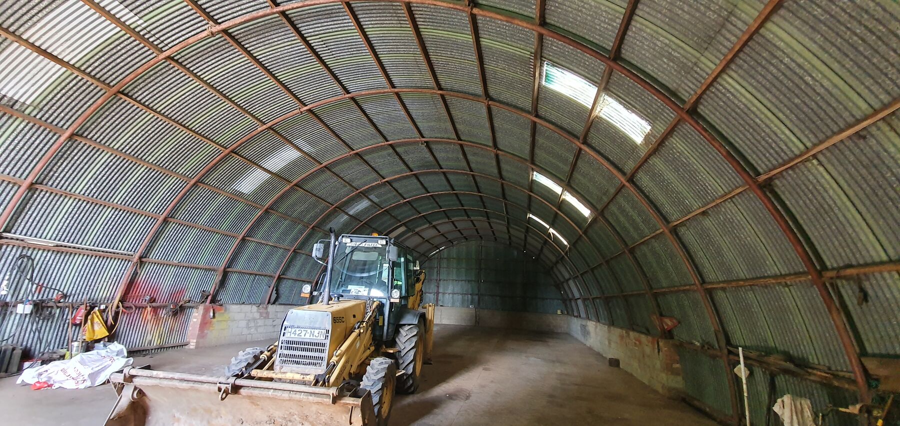 Interior of the curved corrugated agricultural building at Sunningdale Farm before conversion