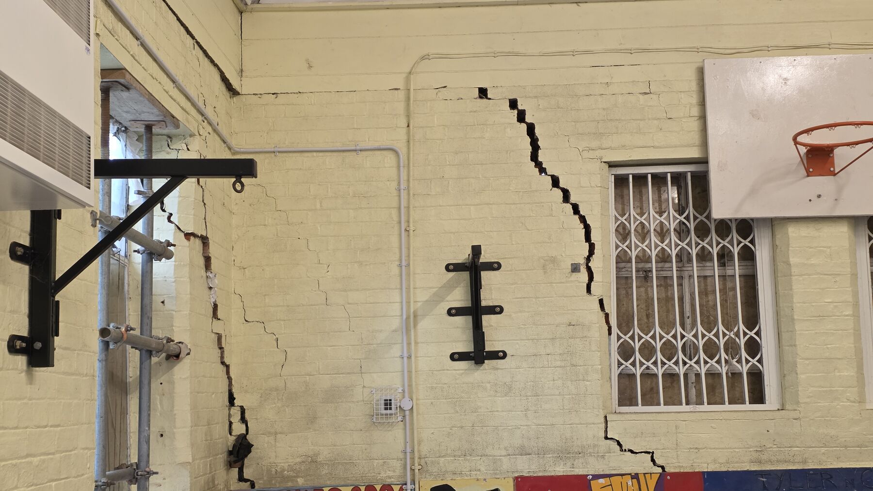 Diagonal crack running through internal blockwork wall at Great Dunmow Youth Centre