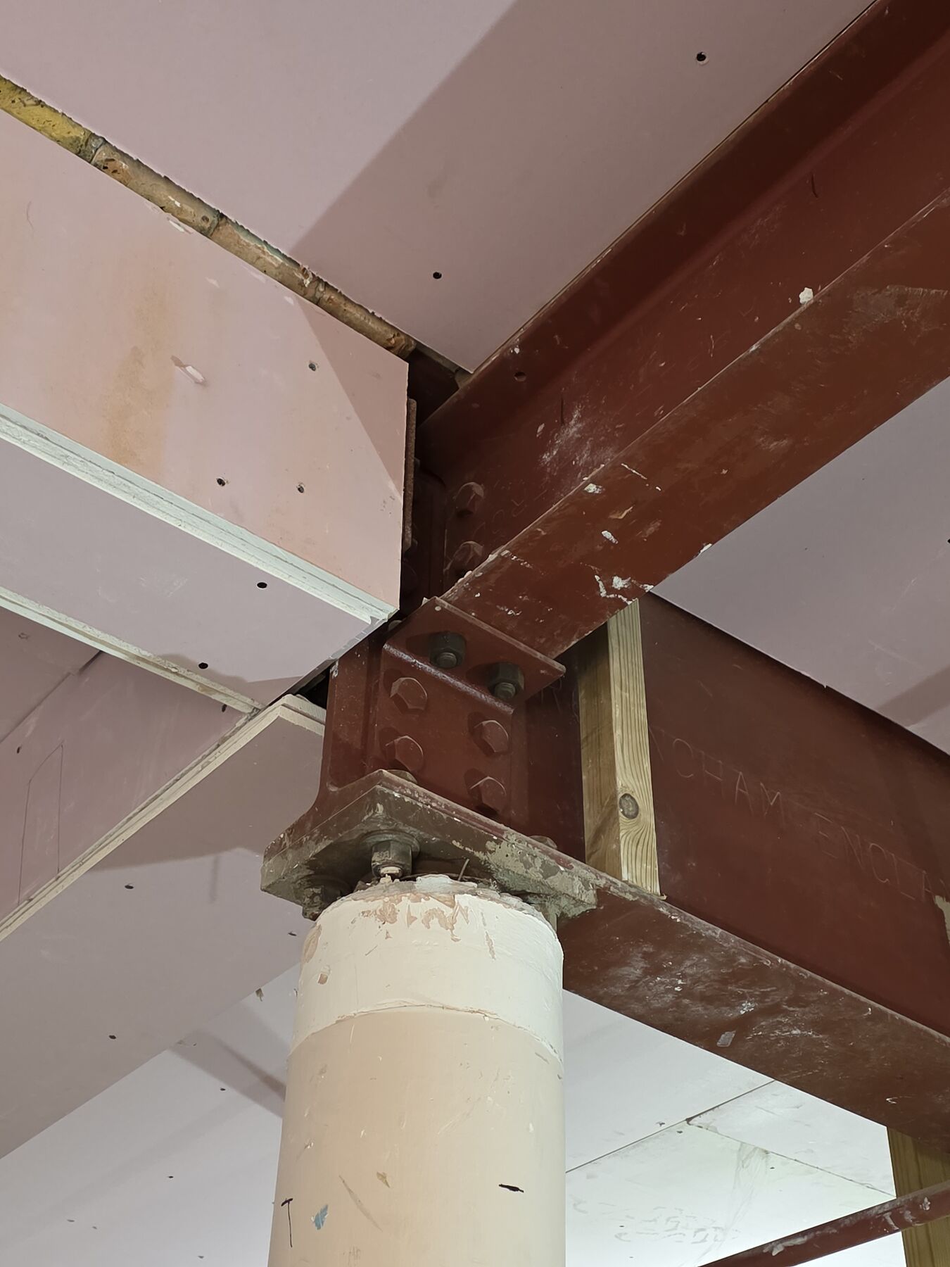 New steel beam bearing onto an existing concrete column inside the Ravens building